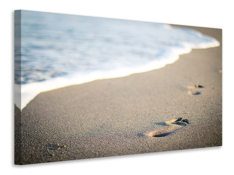 Leinwandbild Fussspuren im Sand am Strand