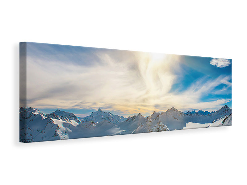 Leinwandbild Panorama Über den verschneiten Gipfeln
