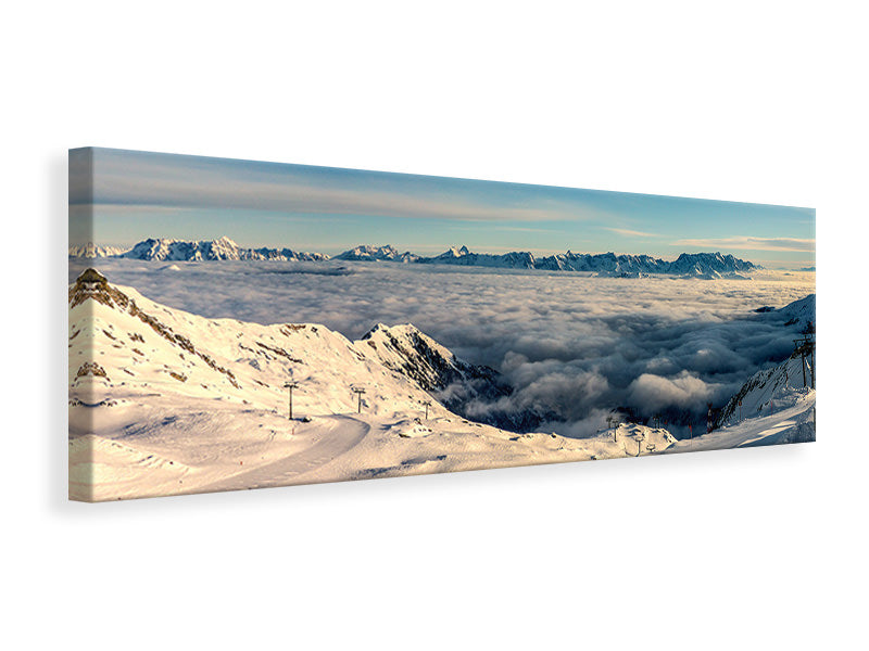 Leinwandbild Panorama Über den Wolken im Schnee